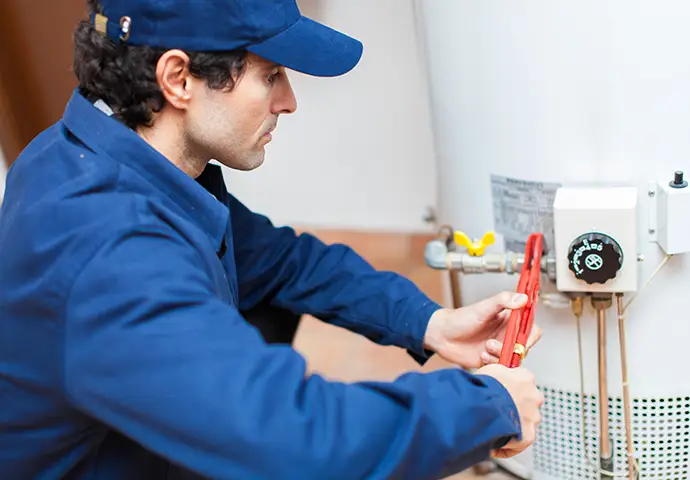 Plumber fixing an hot-water heater